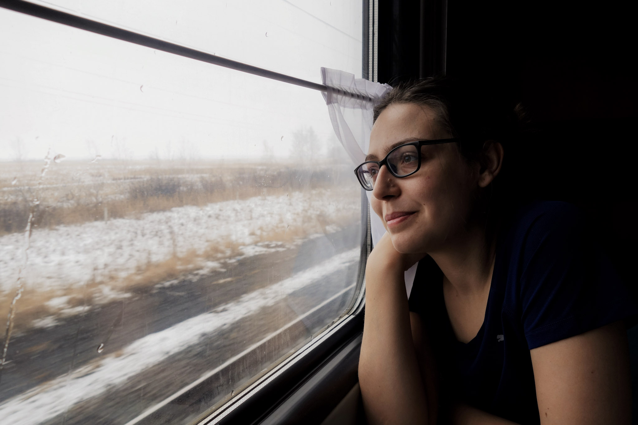 girl smiling at the window in the Transsiberian